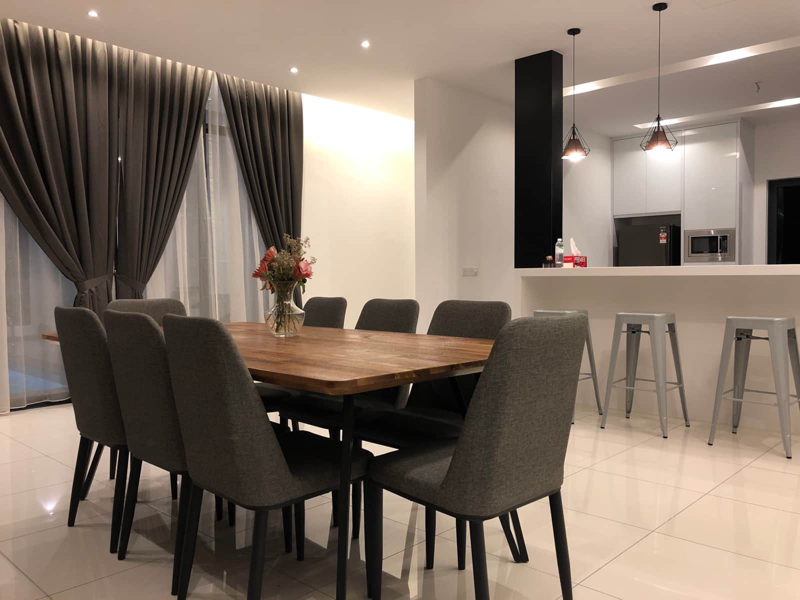 Dining table for ten beside the kitchen bar