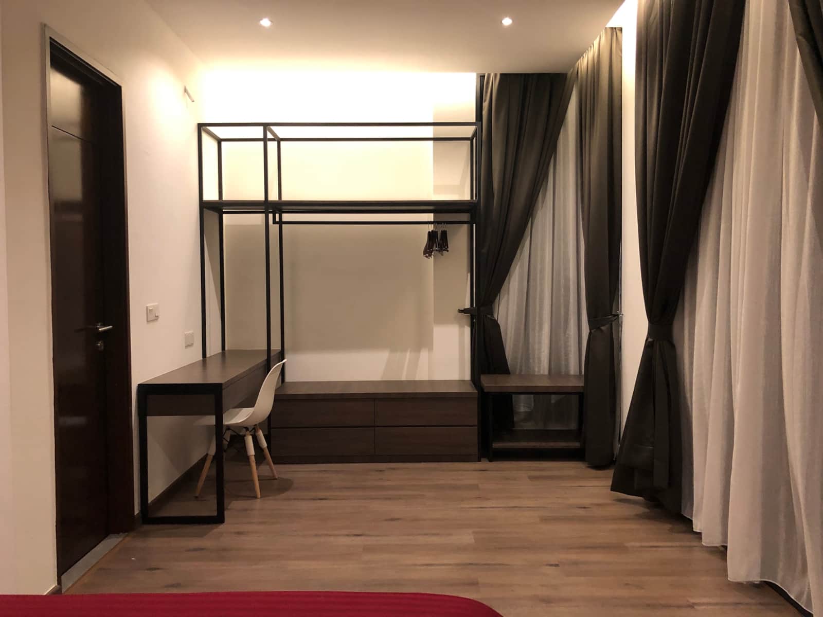 Master bedroom with open wardrobe and desk